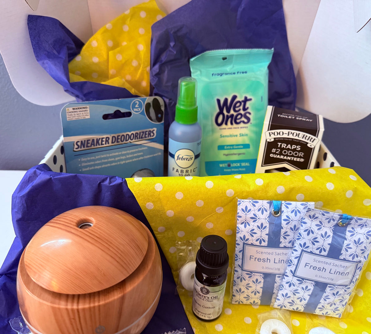 Room Refresh care package with a diffuser, clean cotton fragrance oil, Fresh Linen sachets, sneaker deodorizers, fabric spray, sensitive-skin wipes, and Poo-Pourri.