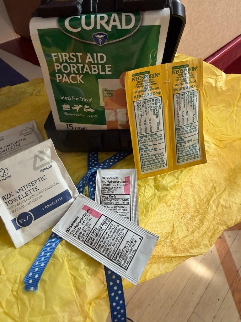 Portable First Aid Kit — adhesive bandages, neosporin, antiseptic towelettes, and hydrocortisone cream